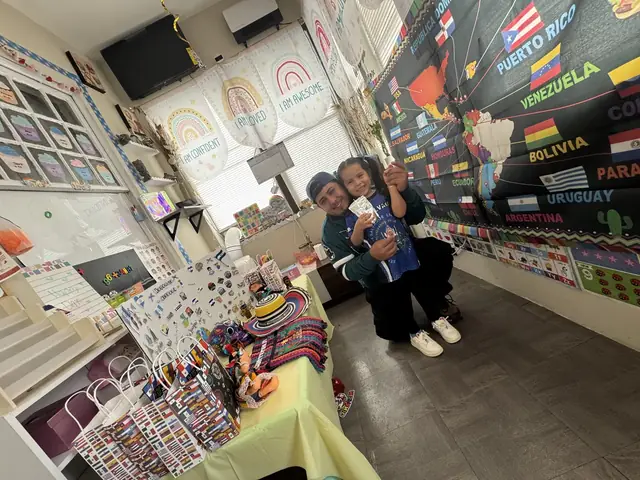A father holds his daughter in the classroom decorated for Hispanic Heritage Day