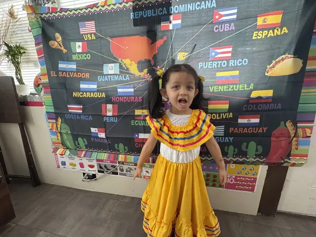 A girl in a yellow dress sings in front of the map